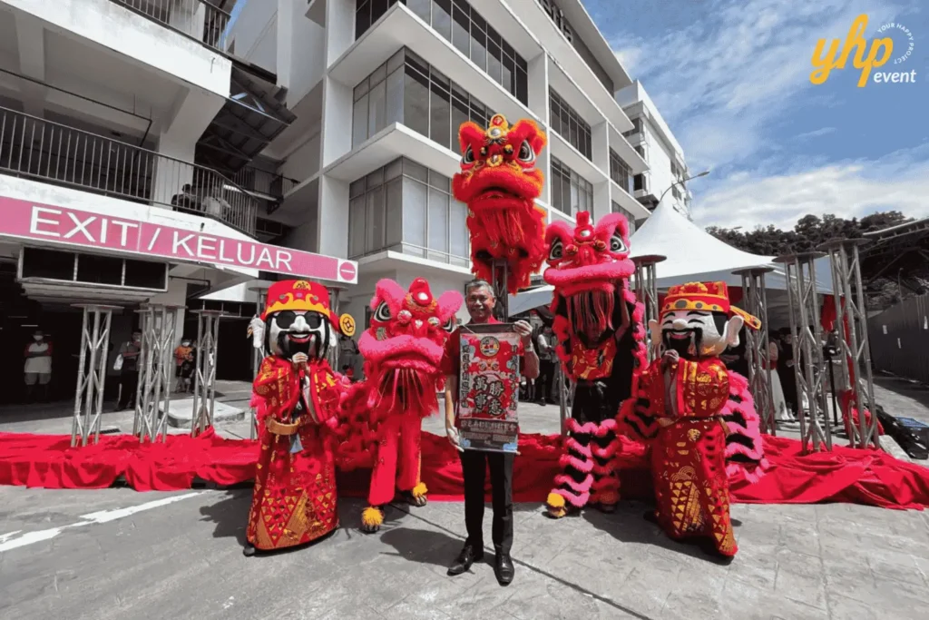 Lion dance performers and God of Prosperity mascots pose with a guest