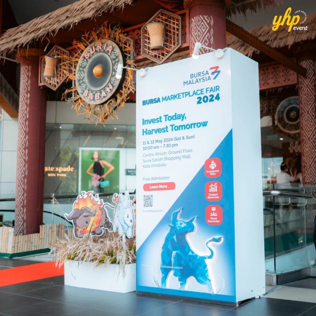 Bursa Marketplace Fair 2024: Invest Today, Harvest Tomorrow 5 Large promotional signage for Bursa Marketplace Fair 2024 at the entrance of Suria Sabah Shopping Mall