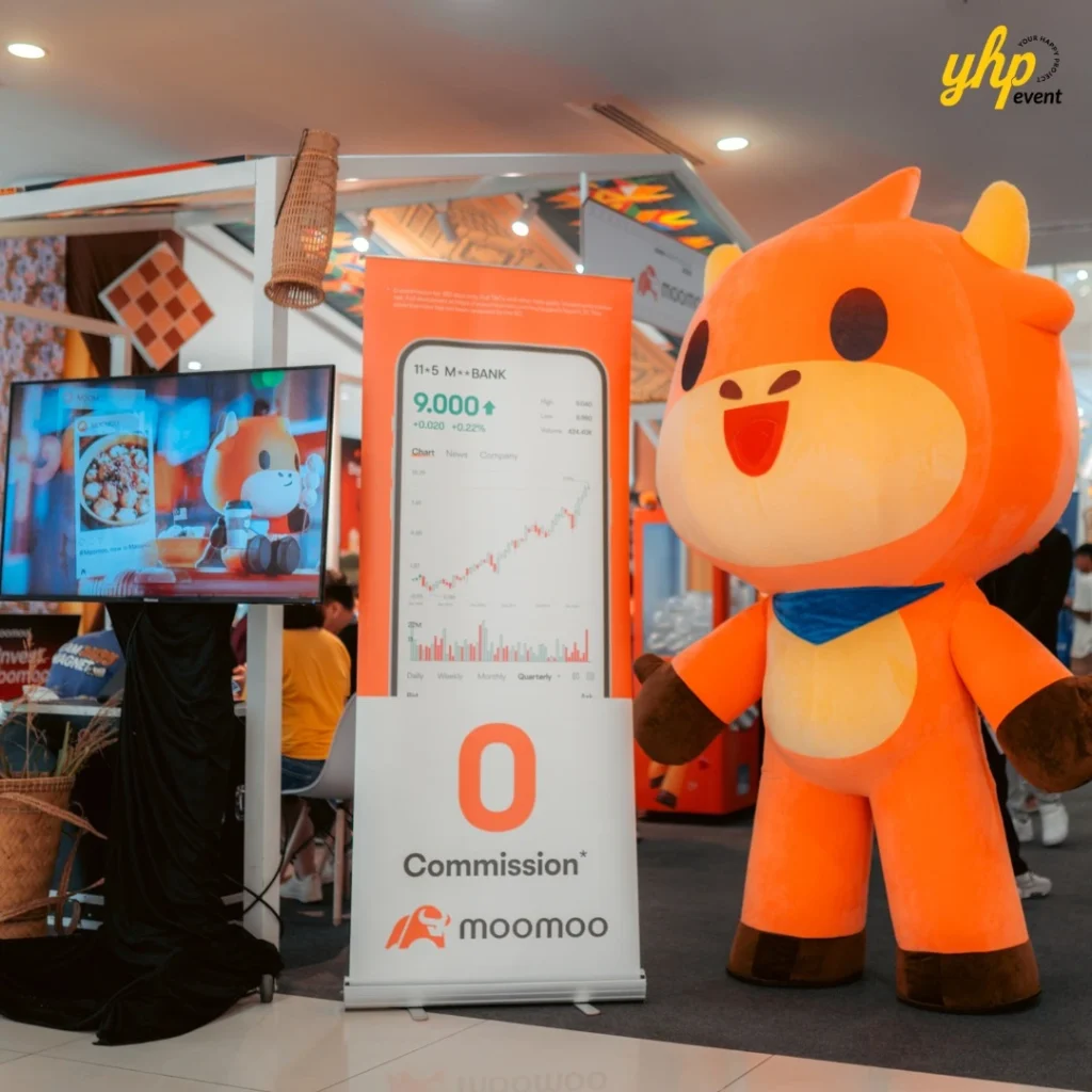 Bursa Marketplace Fair 2024: Invest Today, Harvest Tomorrow 9 Orange Moomoo mascot standing next to a zero commission investment booth at Bursa Marketplace Fair 2024