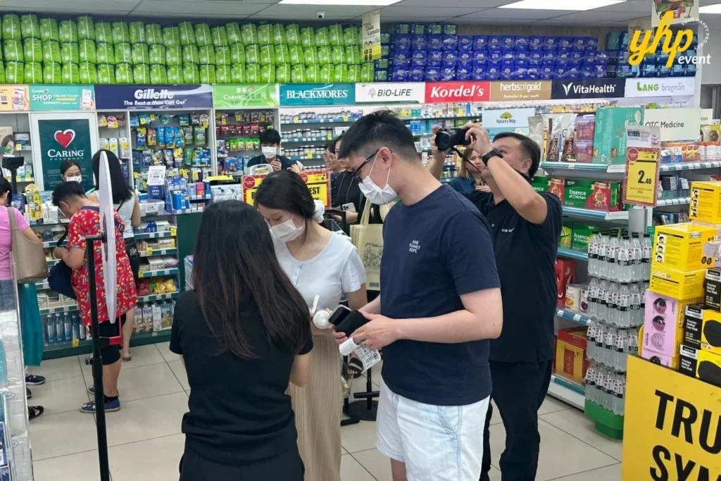 Embrace the Essence of Caring Pharmacy #Promosi Tadau Kaamatan 16 Customers wearing face masks browsing the vitamin and supplement aisles at a Caring Pharmacy branch