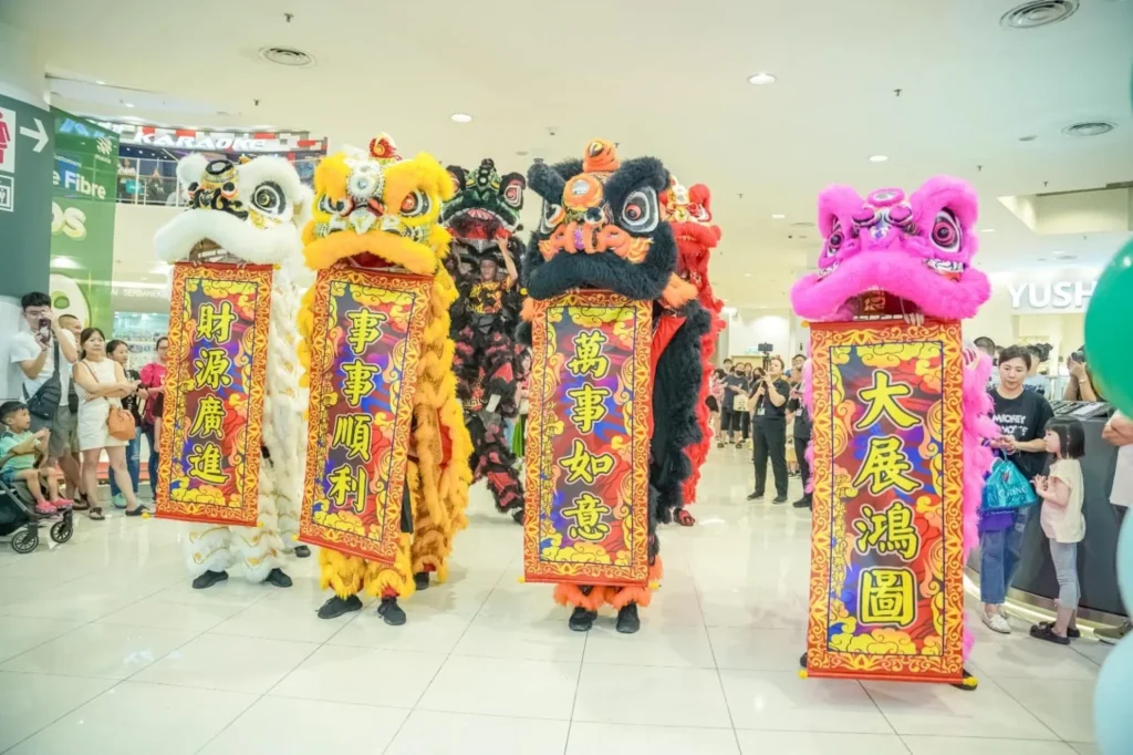 Caring Pharmacy Kaamatan & Gawai Campaign Launch 12 Lion dancers hold vertical blessing banners