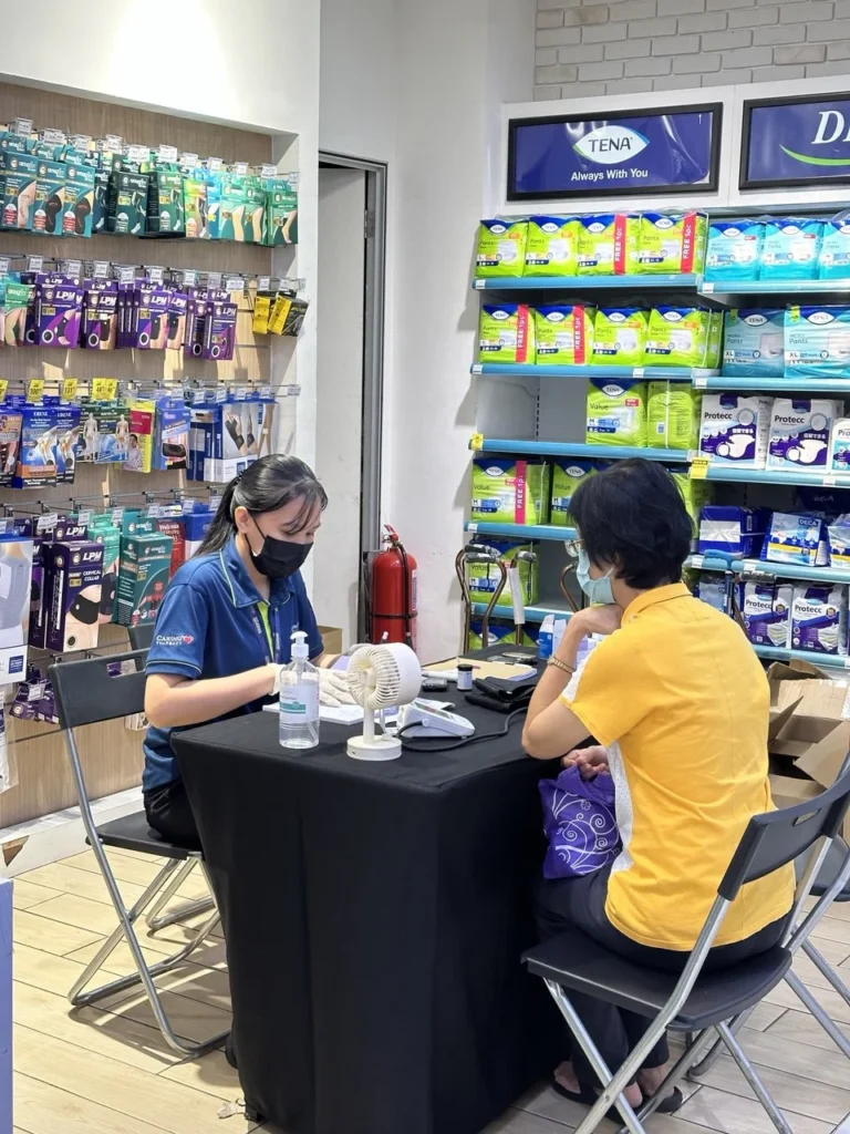 Caring Pharmacy Kaamatan & Gawai Campaign Launch 13 Customer receives a health screening consultation inside Caring Pharmacy