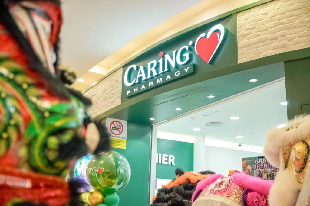 Caring Pharmacy Kaamatan & Gawai Campaign Launch 8 Entrance of Caring Pharmacy decorated with balloons while lion dance heads appear