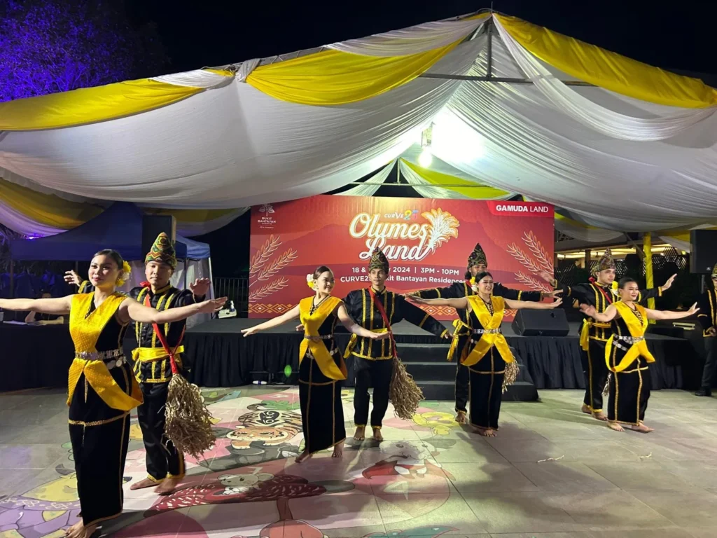 Curve25 Olumes Land : Kaamatan Celebration in Kota Kinabalu 6 Group of dancers in traditional black and yellow Malaysian attire performing a synchronized routine