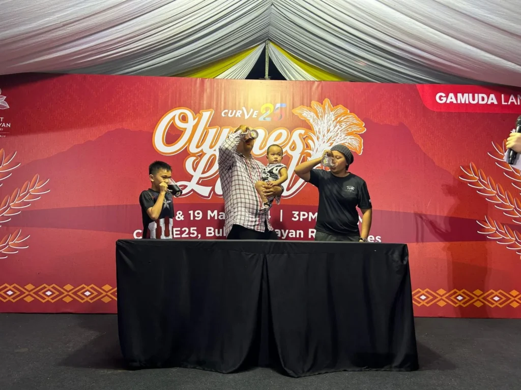 Curve25 Olumes Land : Kaamatan Celebration in Kota Kinabalu 7 Participants taking part in a drinking competition on stage