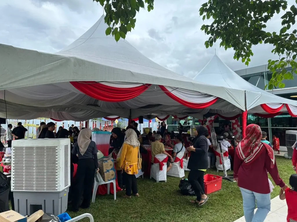 Community gathering under large white marquees during the E Residence Chinese New Year 2025 open house