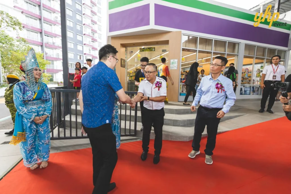 Celebrating the Grand Launch of Curve25 3 YB Phoong Jin Zhe shaking hands with guests on a red carpet