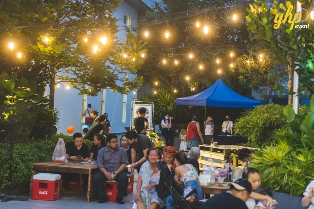 Celebrating the Grand Launch of Curve25 9 Guests relaxing under string lights at the outdoor community plaza