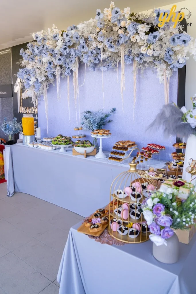 Grand Launching of JIN Omakase: A Culinary Extravaganza in Kota Kinabalu 12 Buffet table at Jin Omakase by Minami featuring gourmet desserts, sandwiches, and blue floral backdrop