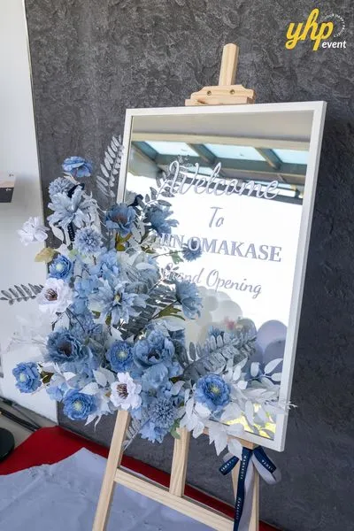 Grand Launching of JIN Omakase: A Culinary Extravaganza in Kota Kinabalu 13 White framed mirror welcome sign for Jin Omakase by Minami decorated with a blue floral arrangement