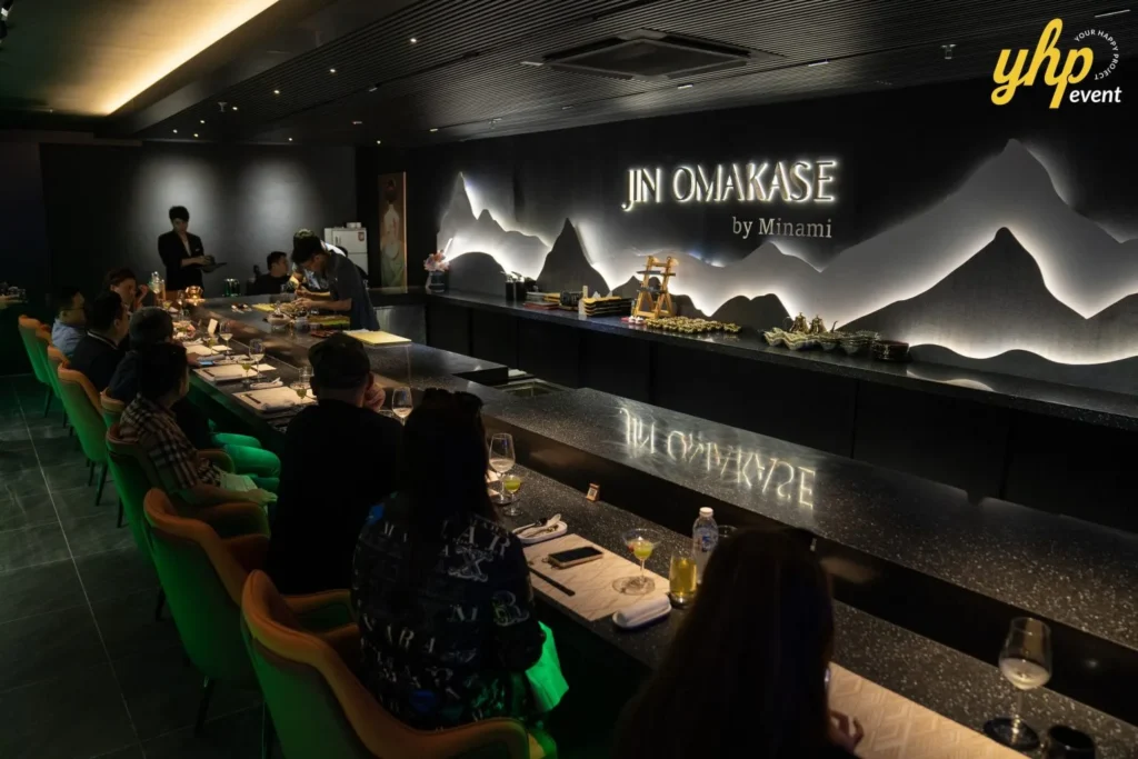 Grand Launching of JIN Omakase: A Culinary Extravaganza in Kota Kinabalu 7 nterior view of Jin Omakase by Minami dining room with guests seated at a black counter and mountain silhouette wall