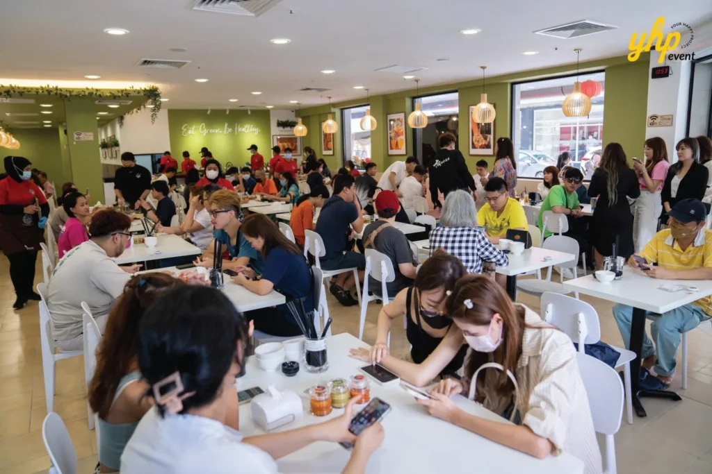 Grand Opening of Young Sanna Mee in Sabah - Enjoy Delicious and Healthy Noodles 6 Busy interior of Young Sanna Mee restaurant with many customers seated at white tables during lunchtime