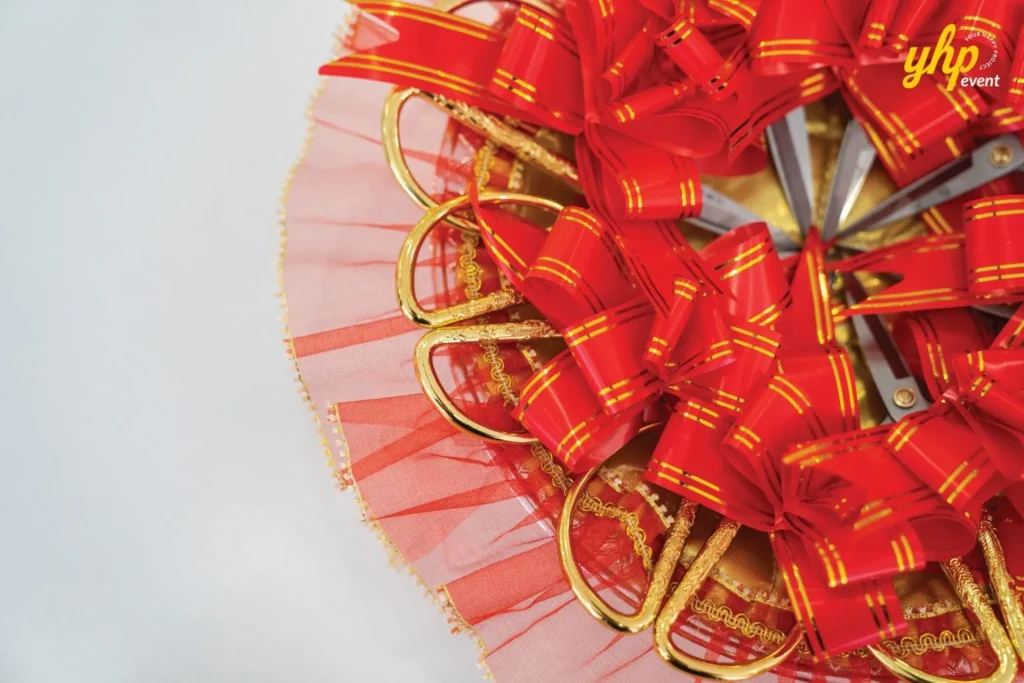 Grand Opening of Young Sanna Mee in Sabah - Enjoy Delicious and Healthy Noodles 10 Close-up of gold-handled scissors and red decorative bows prepared for a Young Sanna Mee ribbon cutting
