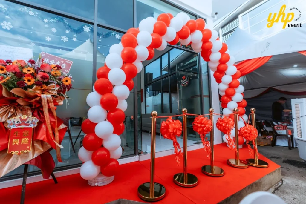 JT Machinery Office Launching 2 Grand opening entrance with red and white balloon arch and ceremonial ribbon cutting stanchions in JT Machinery KK
