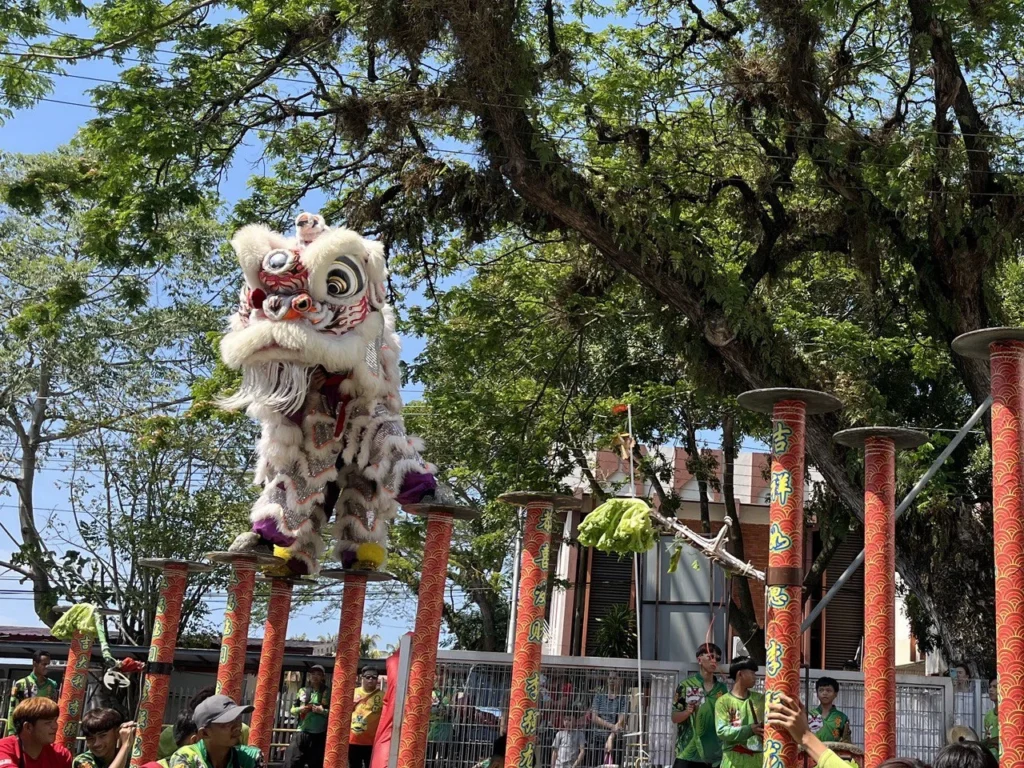 LikasVue CNY Celebration 2024 & A1 Show Unit Launching 4 White lion dance performer balancing on high poles