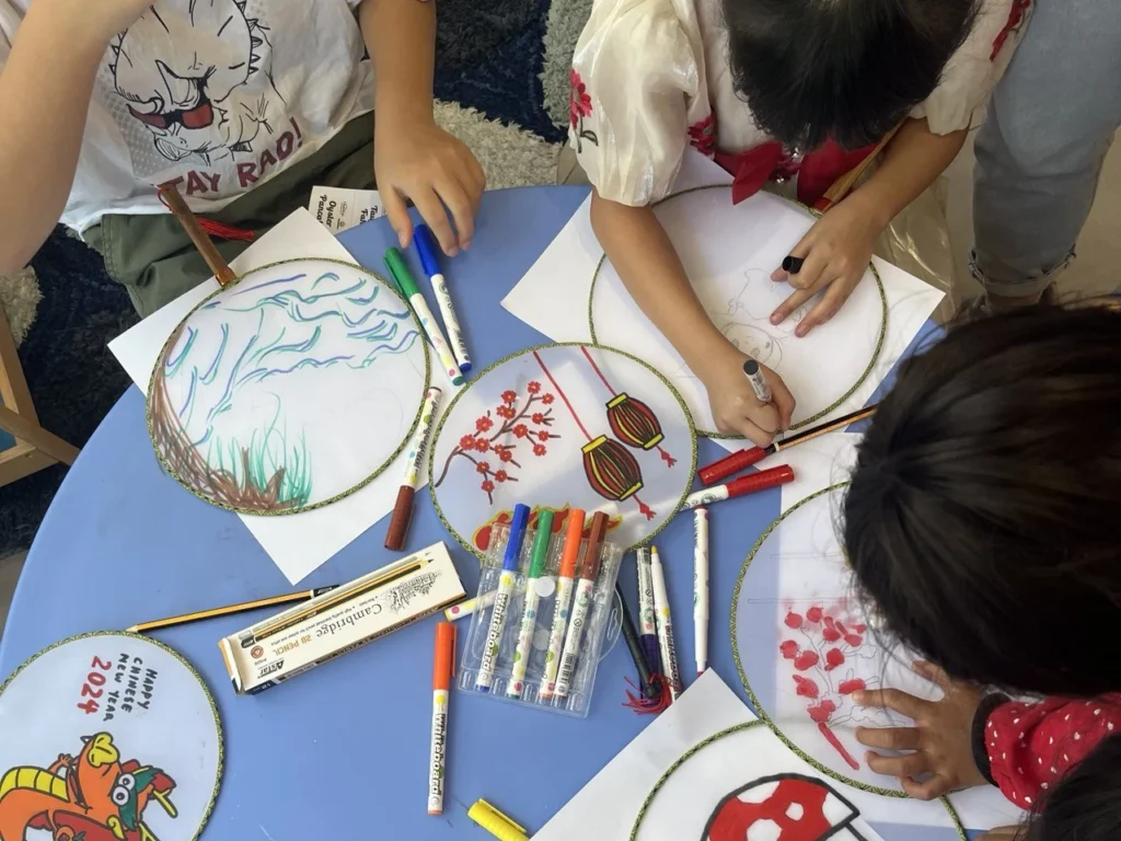 LikasVue CNY Celebration 2024 & A1 Show Unit Launching 5 Children participating in a traditional fan painting workshop in LikasVue sales gallery