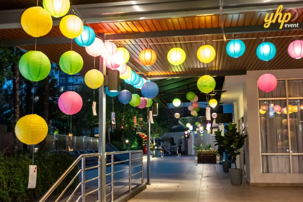 Magical Mid Autumn Gathering in Curve25 2 Colorful round paper lanterns hanging from a ceiling during a festive outdoor Mid-Autumn Festival event