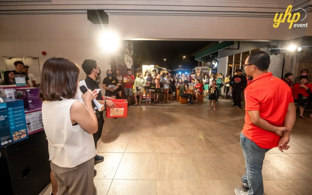 Magical Mid Autumn Gathering in Curve25 15 Event organizers hosting a lucky draw with a voting box during a lively Mid-Autumn Festival community gathering