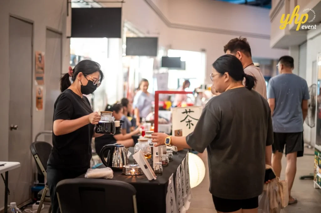 Magical Mid Autumn Gathering in Curve25 17 A vendor wearing a face mask pouring tea at a traditional tea stall during a Mid-Autumn Festival street market