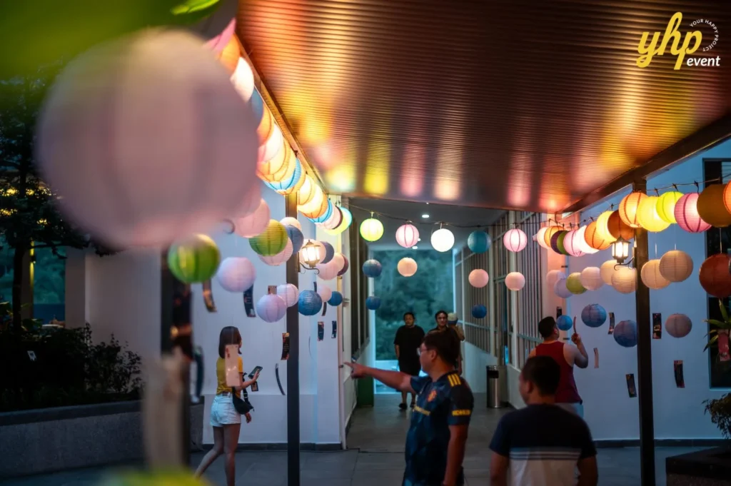 Magical Mid Autumn Gathering in Curve25 4 People walking under a canopy of multi-colored Mid-Autumn Festival lanterns