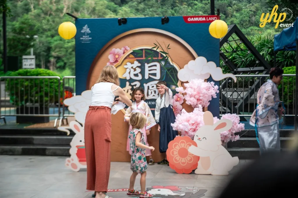 Magical Mid Autumn Gathering in Curve25 8 Families and children taking photos at a Mid-Autumn Festival garden setup with rabbits and cherry blossoms