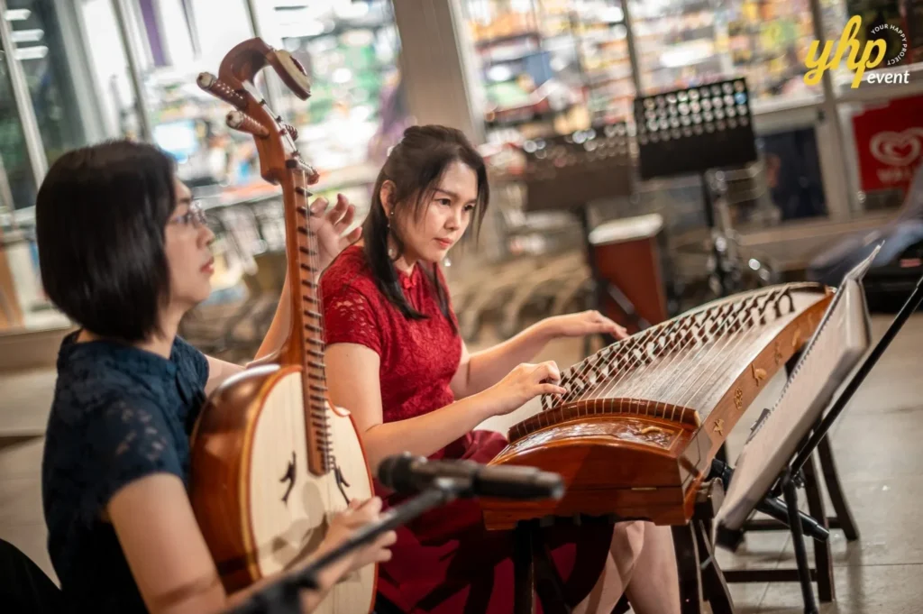 Magical Mid Autumn Gathering in Curve25 9 Two women performing traditional Chinese music on a Pipa and Guzheng during a Mid-Autumn Festival event