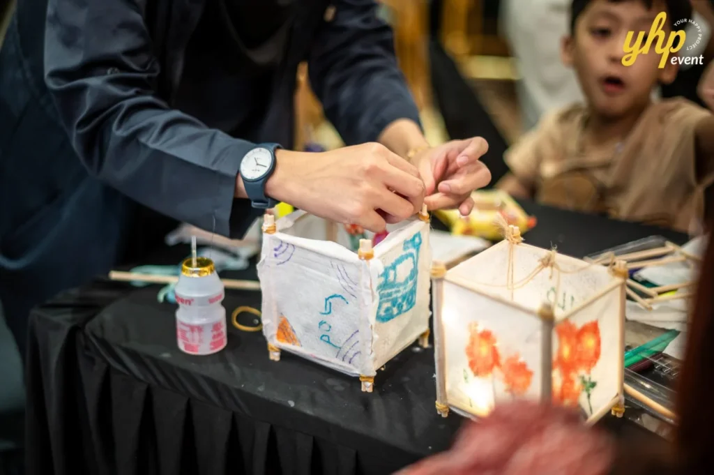 Magical Mid Autumn Gathering in Curve25 10 Hands assembling a handmade square paper lantern during a Mid-Autumn Festival craft workshop for kids