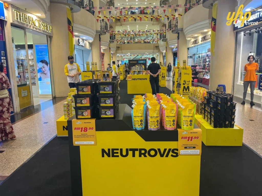 Unveiling Neutrovis: Beyond Masks, Into Complete Protection 3 Close-up of NEUTROVIS detergent and shower gel products on yellow display stands with price tags