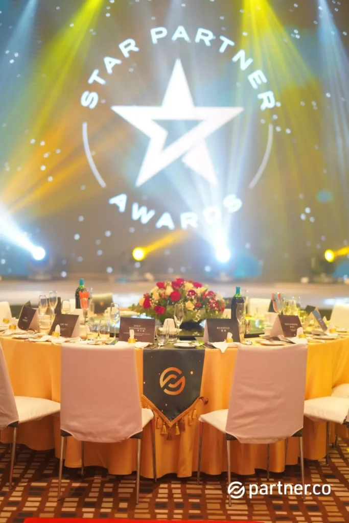 Unleashing the Future of Business: Partner.Co's Star Partner Business Conference & Award Night 2 Star Partner Awards gala dinner table setting with floral centerpiece and gold linens at Partner.Co event in Marriot Hotel Kota Kinabalu