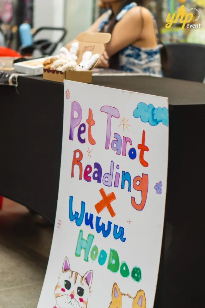 Colorful handmade sign for Pet Tarot Reading at a community pet event booth with cat and dog drawings