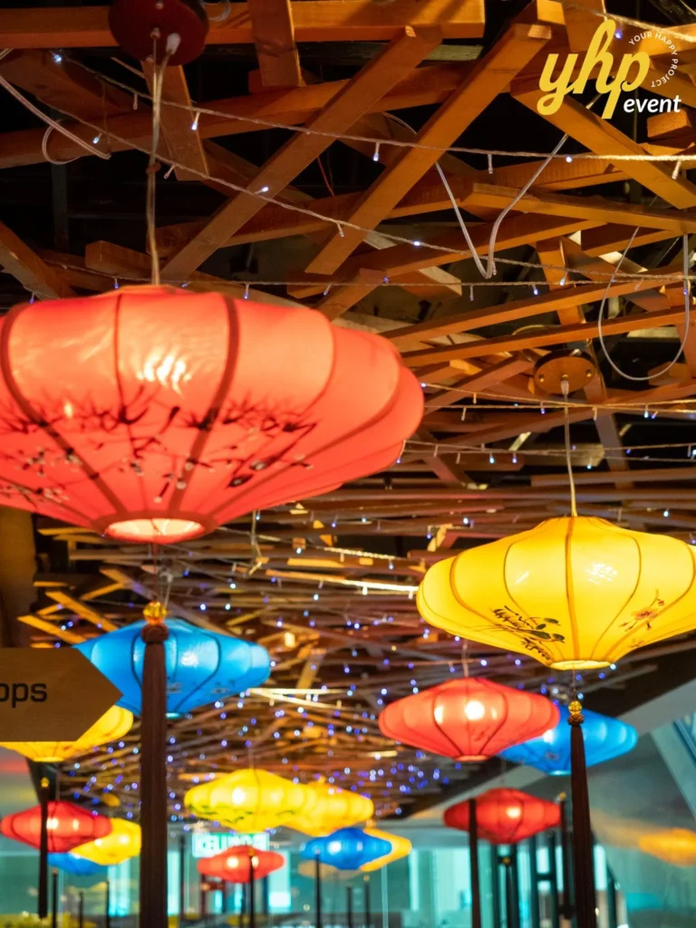 Riverson - Christmas & Lunar New Year Decoration 12 Colorful oriental silk lanterns hanging from a wooden lattice ceiling for an indoor event