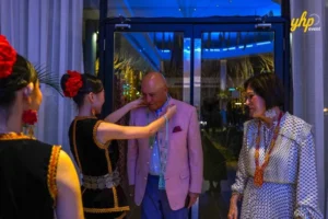 Sabah Culture- Vinusak A guest receives a traditional beaded necklace welcome from a dancer at a gala dinner