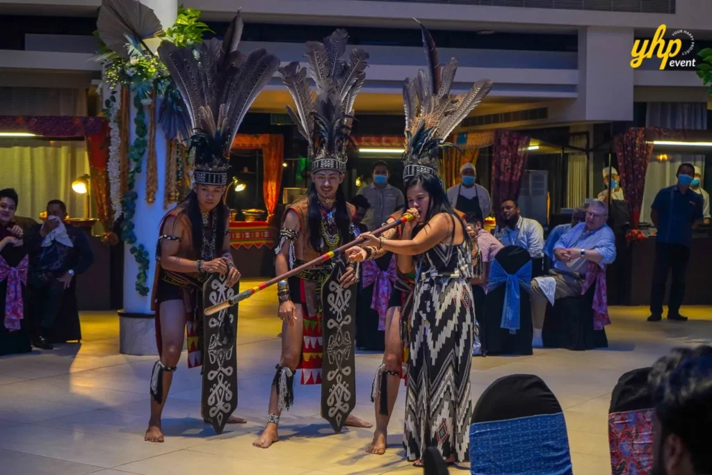 Sabah Warrior Blowpipe A performer demonstrating blowpipe skills in front of guests at the SEALA gala dinner
