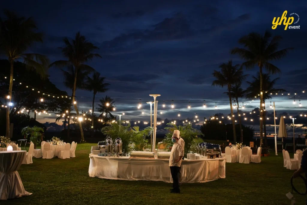 YHP Event - white party Elegant outdoor buffet setup with string lights and white linens for a tropical seaside dinner party at Shangrila Rasa Ria Hotel