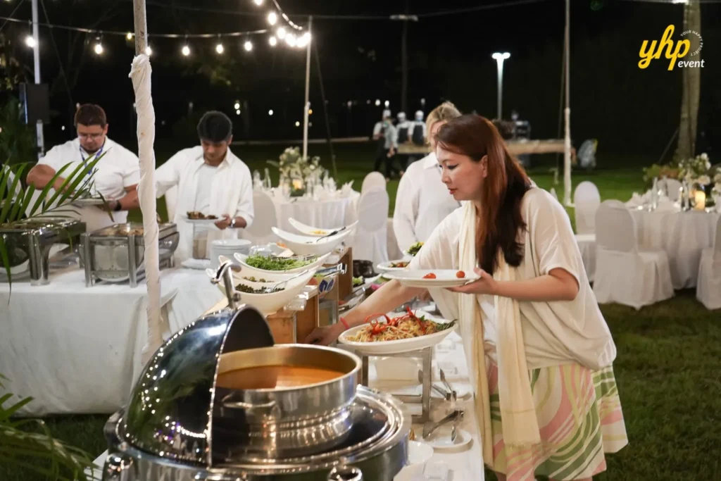 shangrila rasa ria Guest serving herself from a gourmet buffet station at a catered outdoor event