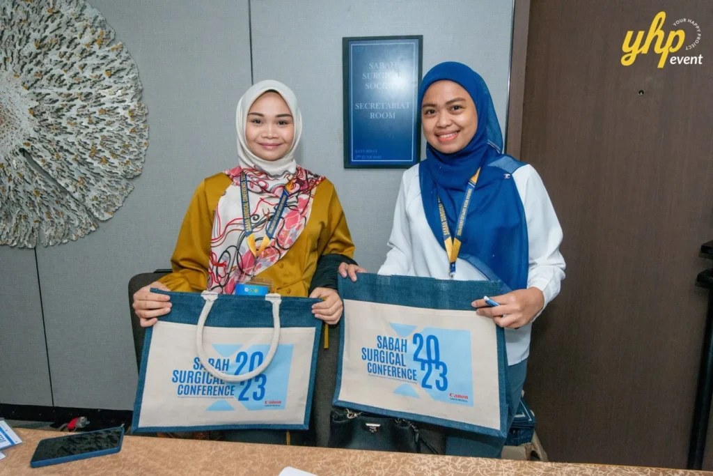 Exploring Advancements in Surgical Care: Highlights from the Sabah Surgical Conference 5 Staff members holding branded tote bags