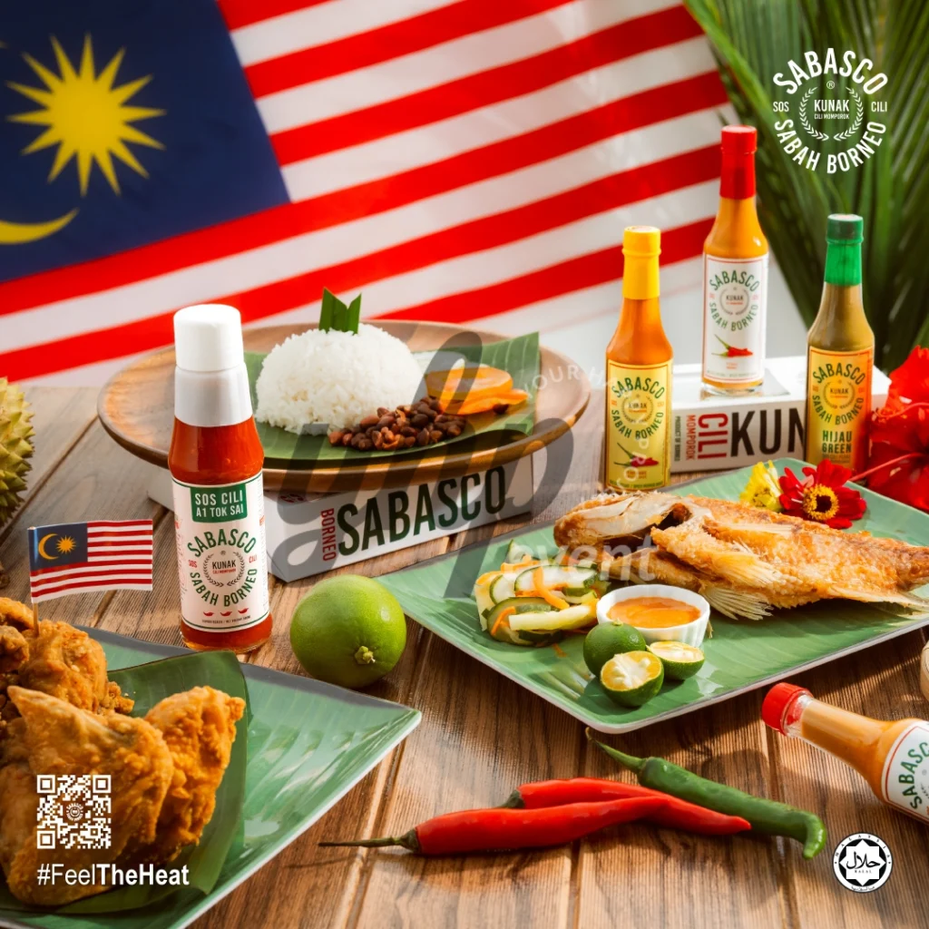 The Local Sabah Chili Sauce Brand That’s Heating Up 19 Sabasco Sabah Borneo chili sauce with Malaysian flag, rice, fried fish, fried chicken, and chilies on a wooden table