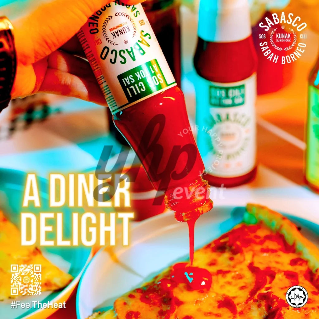 The Local Sabah Chili Sauce Brand That’s Heating Up 23 Hand pouring Sabasco Sabah Borneo chili sauce onto a flatbread dish with other sauce bottles in the background