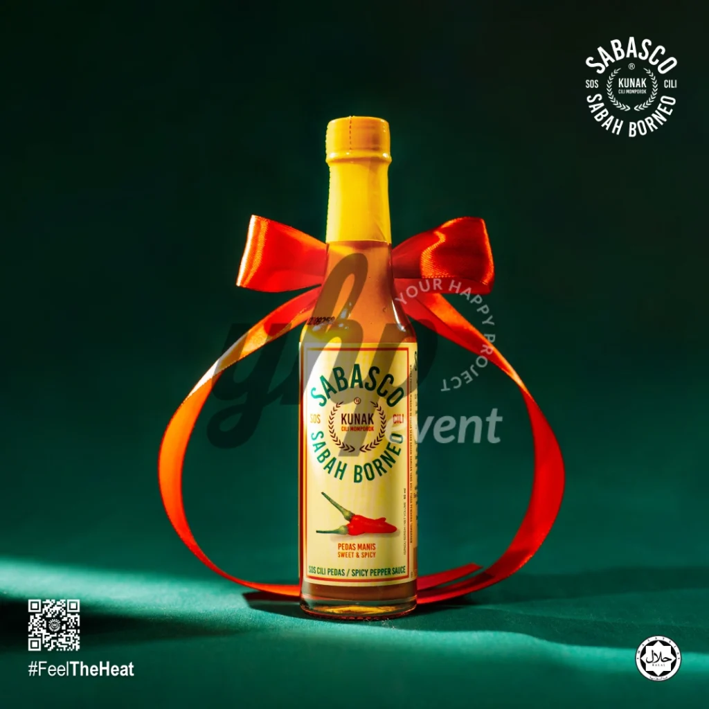 The Local Sabah Chili Sauce Brand That’s Heating Up 34 Sabasco Sabah Borneo sweet and spicy chili sauce bottle tied with a large red ribbon on a green backdrop