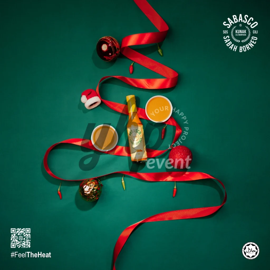 The Local Sabah Chili Sauce Brand That’s Heating Up 35 Holiday flat lay featuring Sabasco Sabah Borneo chili sauce, ornaments, ribbons, and dipping sauce cups