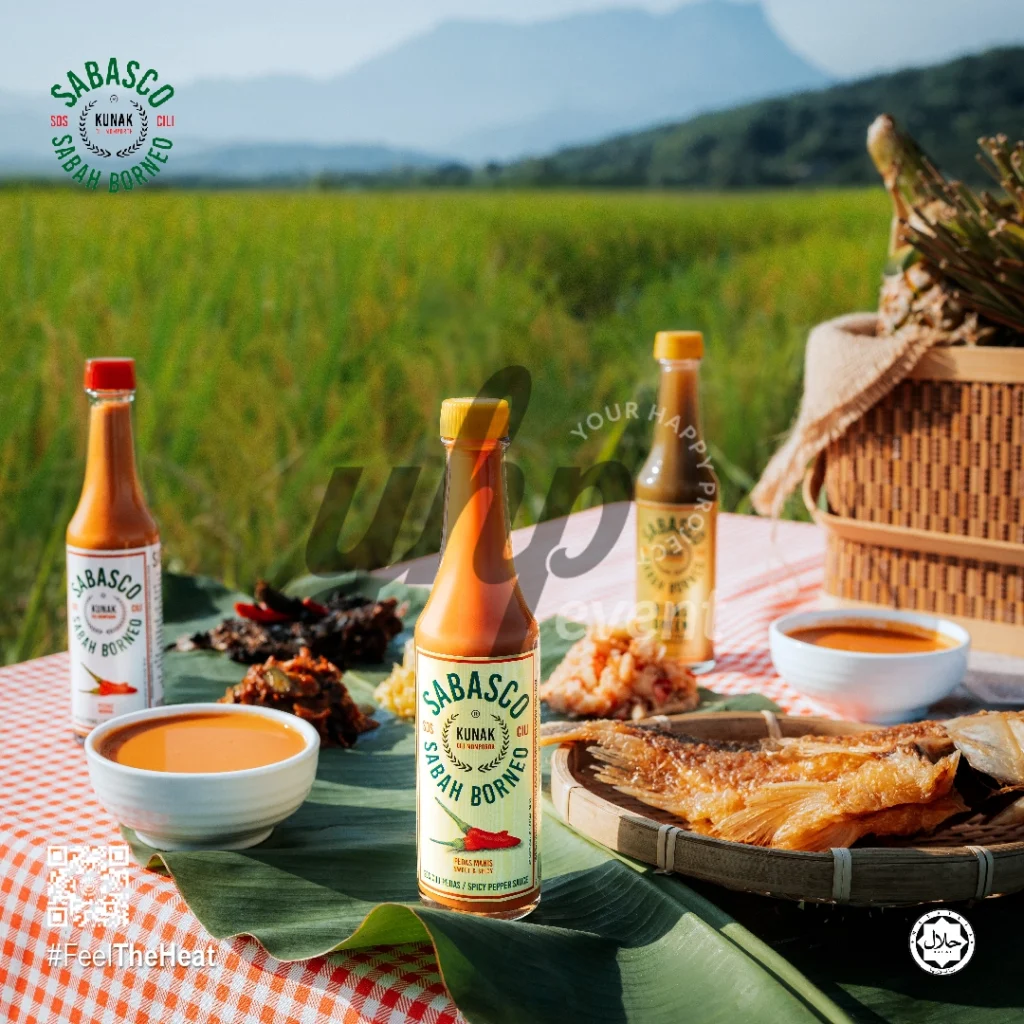 The Local Sabah Chili Sauce Brand That’s Heating Up 15 Sabasco Sabah Borneo chili sauce bottles served picnic-style with grilled fish and sauces in a green rice field