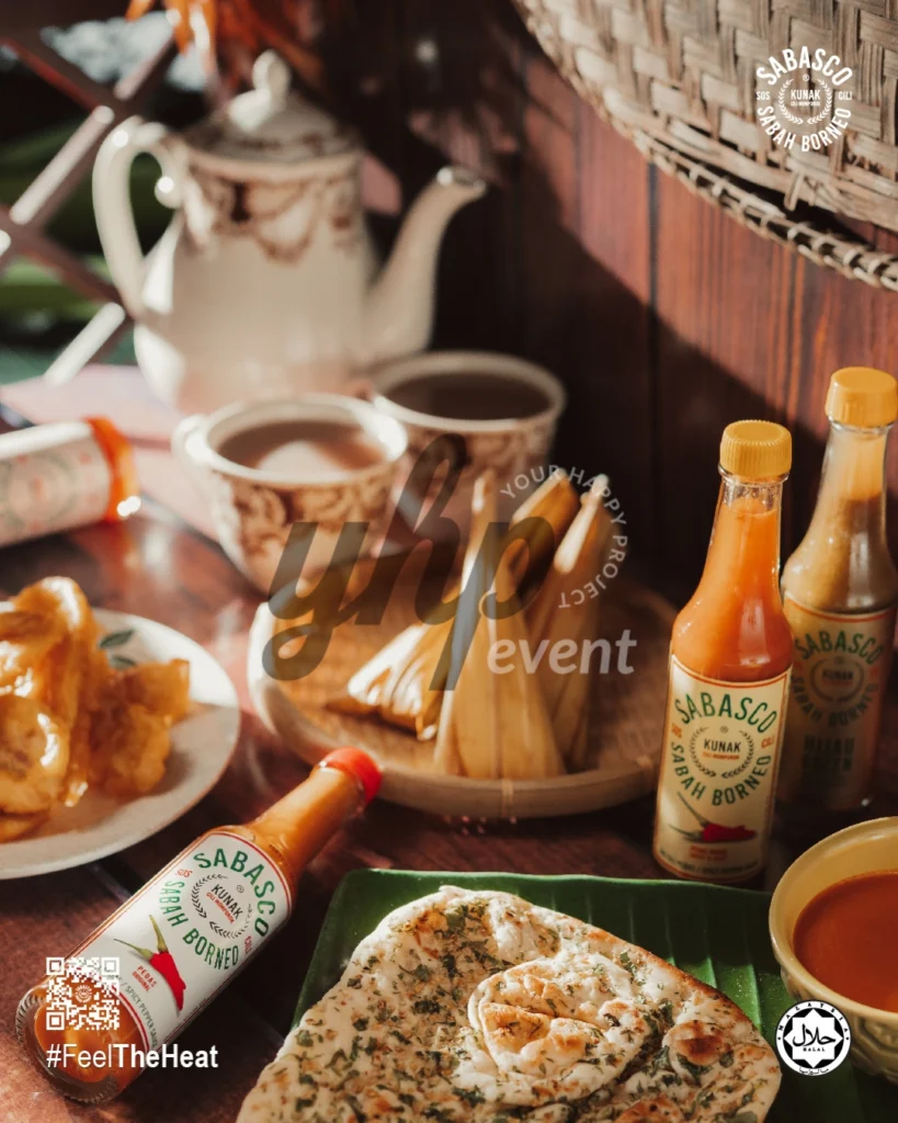 The Local Sabah Chili Sauce Brand That’s Heating Up 3 Sabasco Sabah Borneo chili sauce served with tea, bread, and local snacks on a warmly lit rustic table