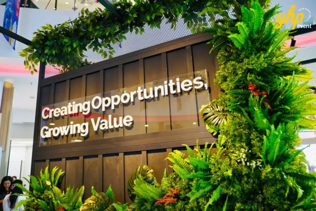 Bursa Marketplace Fair 2024: Sarawak Edition 14 Decorative foliage surrounding a sign reading Creating Opportunities, Growing Value at Bursa Fair in Kuching