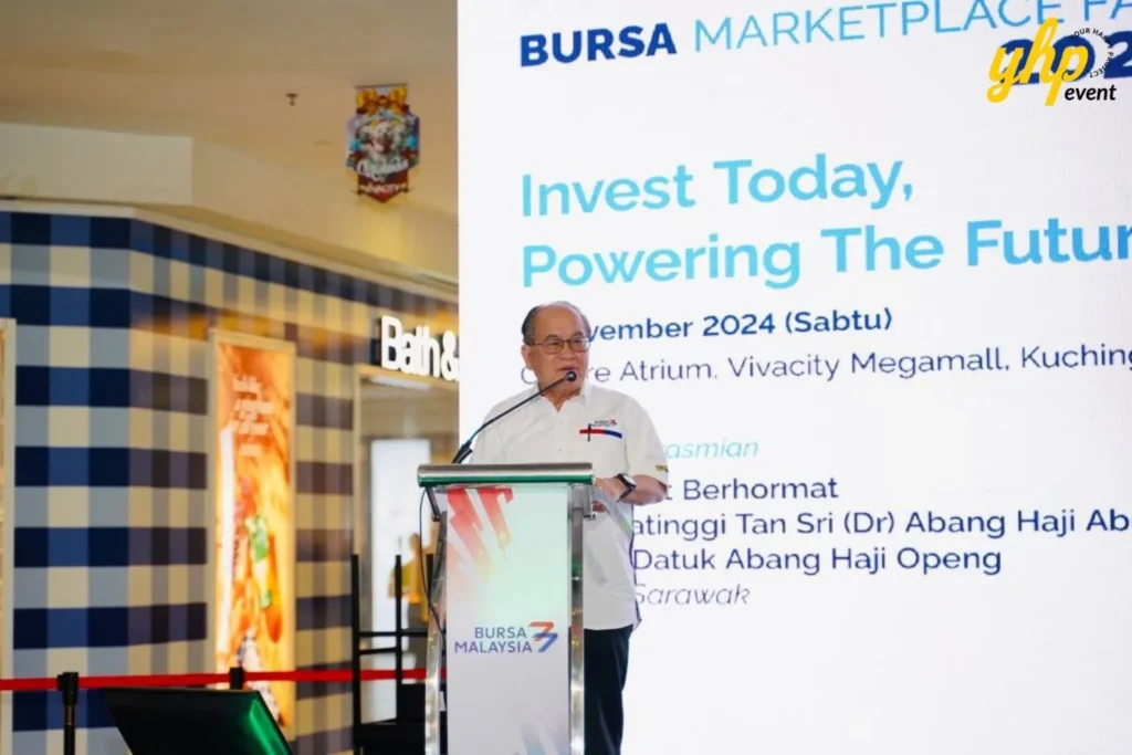 Bursa Marketplace Fair 2024: Sarawak Edition 6 A keynote speaker addresses the crowd from a branded podium during the official Bursa Marketplace Fair 2024 in Kuching