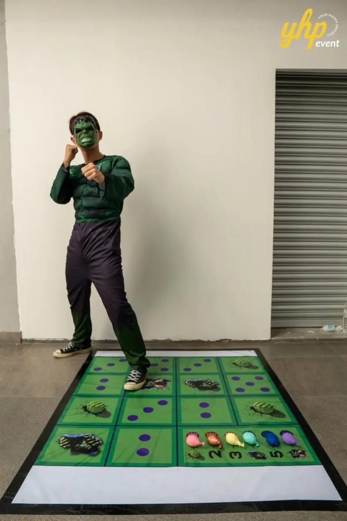 Super Kids Explorer: An Exciting Adventure at Bukit Bantayan 11 A man in a Hulk costume strikes a pose next to a numbered floor mat game