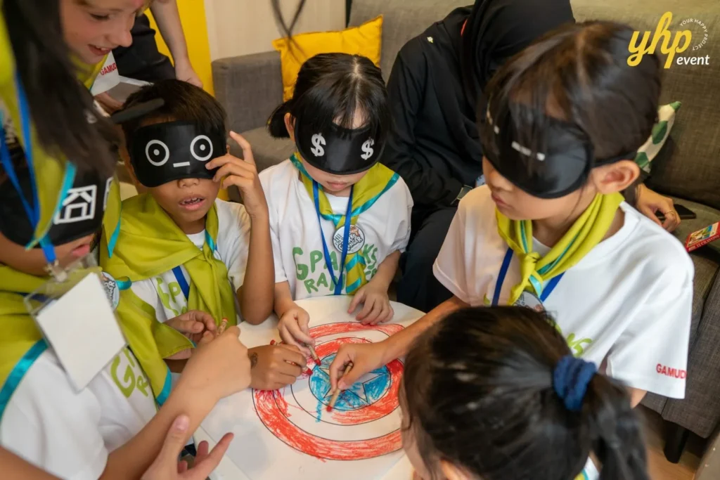 Super Kids Explorer: An Exciting Adventure at Bukit Bantayan 13 Blindfolded children work together to color Captain America's shield
