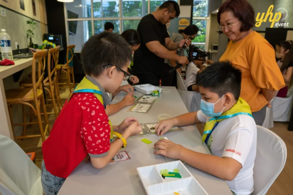 Super Kids Explorer: An Exciting Adventure at Bukit Bantayan 15 Two boys collaborate on building a small motor during a robotics workshop