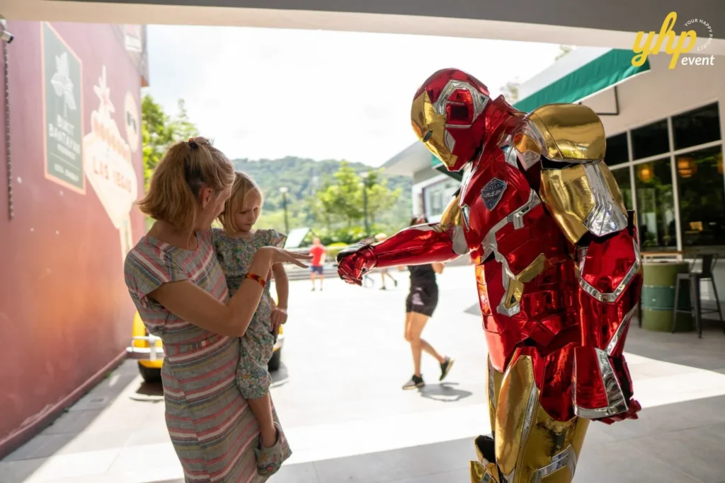 Super Kids Explorer: An Exciting Adventure at Bukit Bantayan 10 Iron Man mascot performs a fist bump with a young child and mother