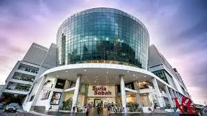 Discover the Top Event Roadshow Venues in Kota Kinabalu, Sabah 9 Exterior view of Suria Sabah Shopping Mall with its iconic curved glass facade at twilight
