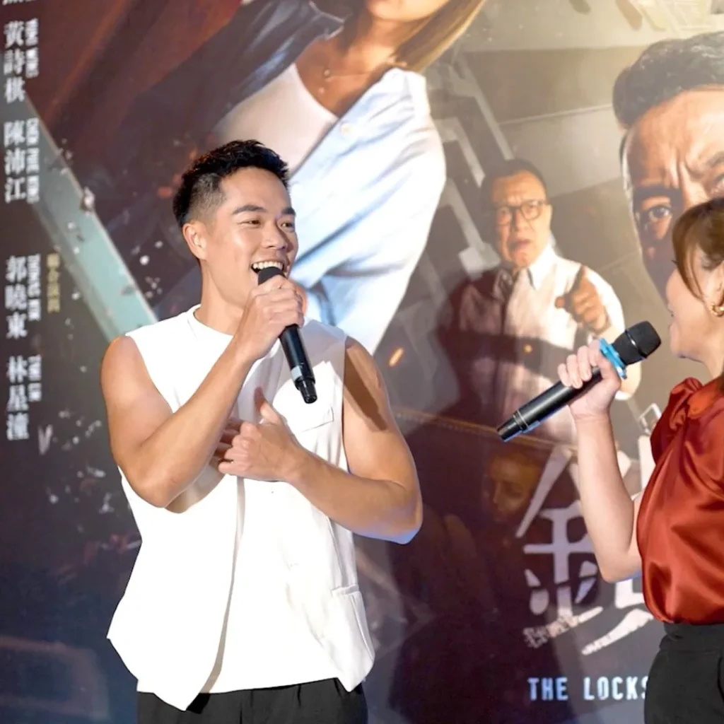 The Locksmith x Chicken Claypot Sabah Meet & Greet 3 Close-up of a male actor speaking into a microphone at The Locksmith movie promotional event in front of a poster